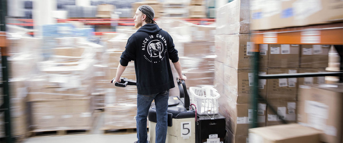 A person driving a forklift full of boxes across our warehouse
